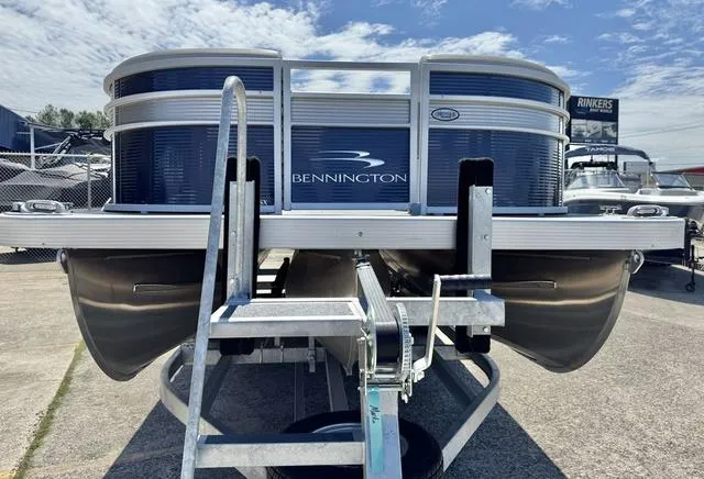 Slide: The Image of 2023 Bennington SX Fish 22 SXFAPG pontoon boat on a trailer under a blue sky. - 9