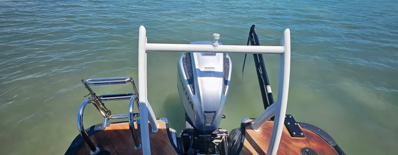 Slide: The Image of 2017 South Bay 500 boat with outboard motor on calm water. - 19