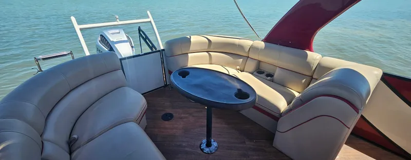 Slide: The Image of Luxurious 2017 South Bay 500 boat interior with plush seating and table on calm water. - 20