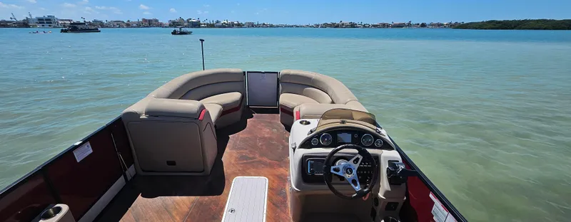 Slide: The Image of 2017 South Bay 500 boat interior with steering wheel and seating on calm water. - 22