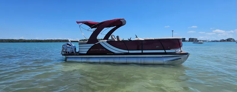 Slide: The Image of 2017 South Bay 500 pontoon boat on calm water under clear blue sky. - 3