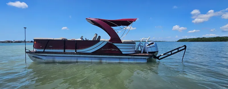 Slide: The Image of 2017 South Bay 500 pontoon boat on calm water under clear blue sky. - 8
