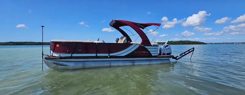 Slide: The Image of 2017 South Bay 500 pontoon boat on a calm lake under a clear blue sky. - 9