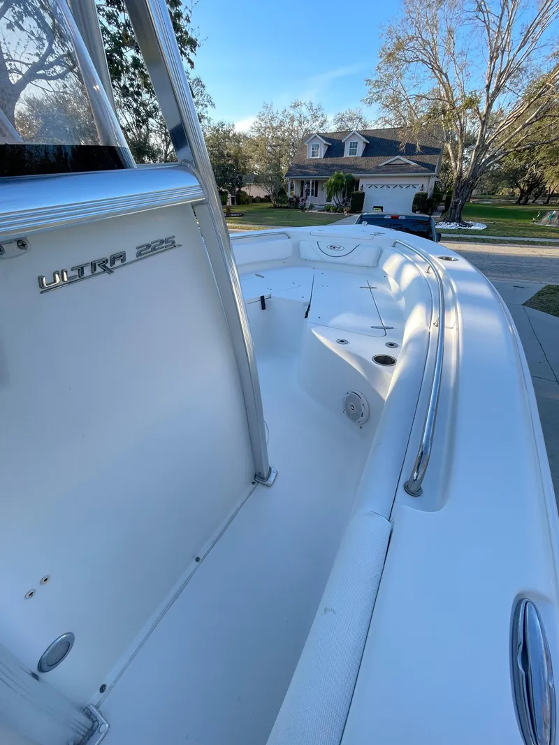 Slide: The Image of 2017 Sea Hunt 225 Ultra boat with trailer, sleek design, parked in residential area. - 10