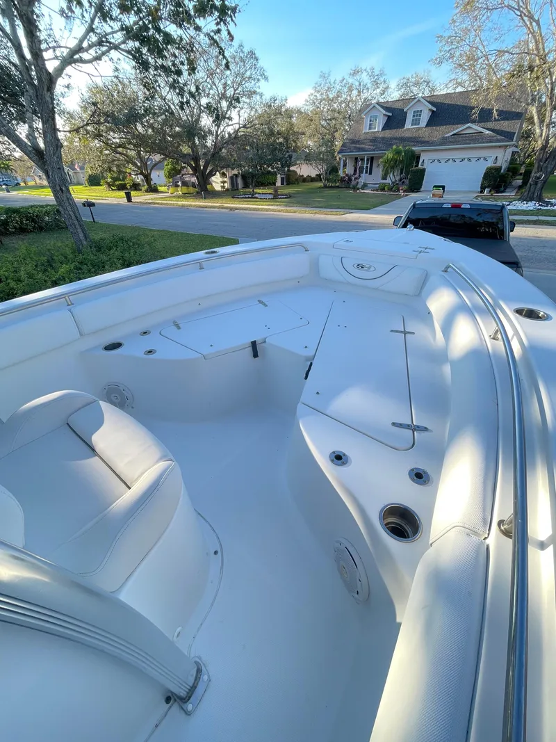 Slide: The Image of 2017 Sea Hunt 225 Ultra boat with trailer, spacious deck, residential background. - 11