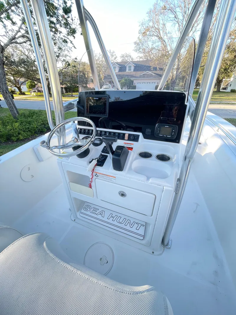 Slide: The Image of 2017 Sea Hunt 225 Ultra boat dashboard with steering wheel and controls. - 12