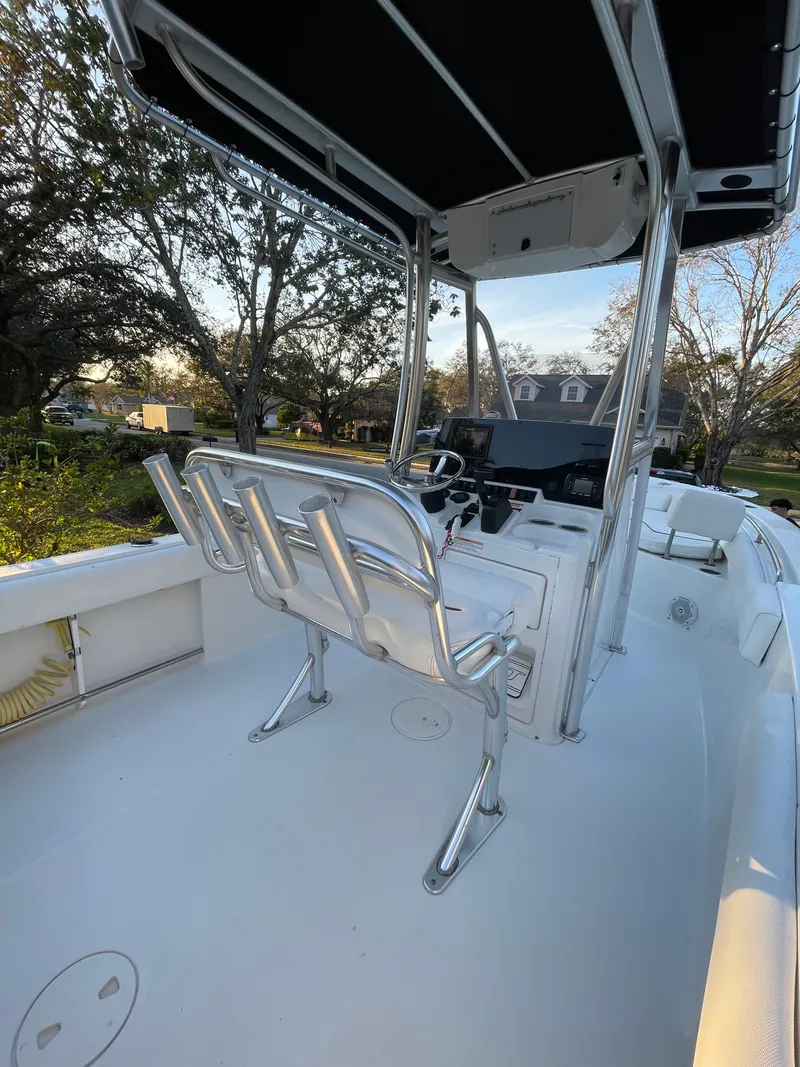 Slide: The Image of 2017 Sea Hunt 225 Ultra boat with T-top, helm seating, and spacious deck. - 20