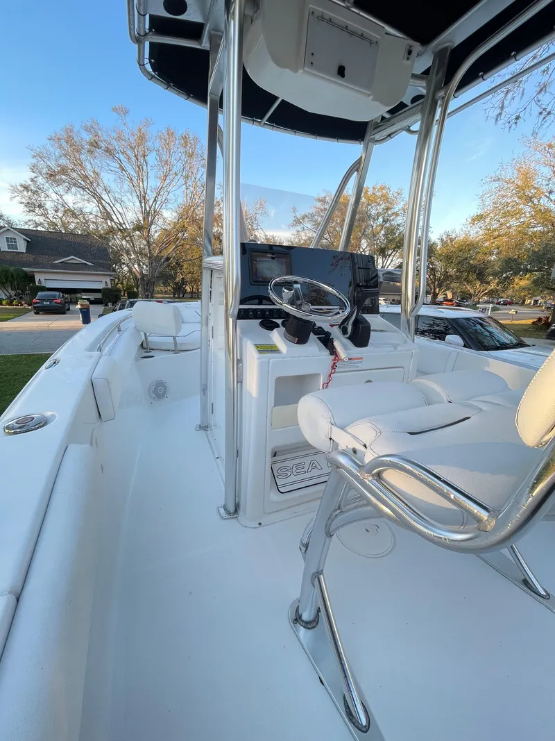 Slide: The Image of 2017 Sea Hunt 225 Ultra boat interior with steering console and seating. - 22