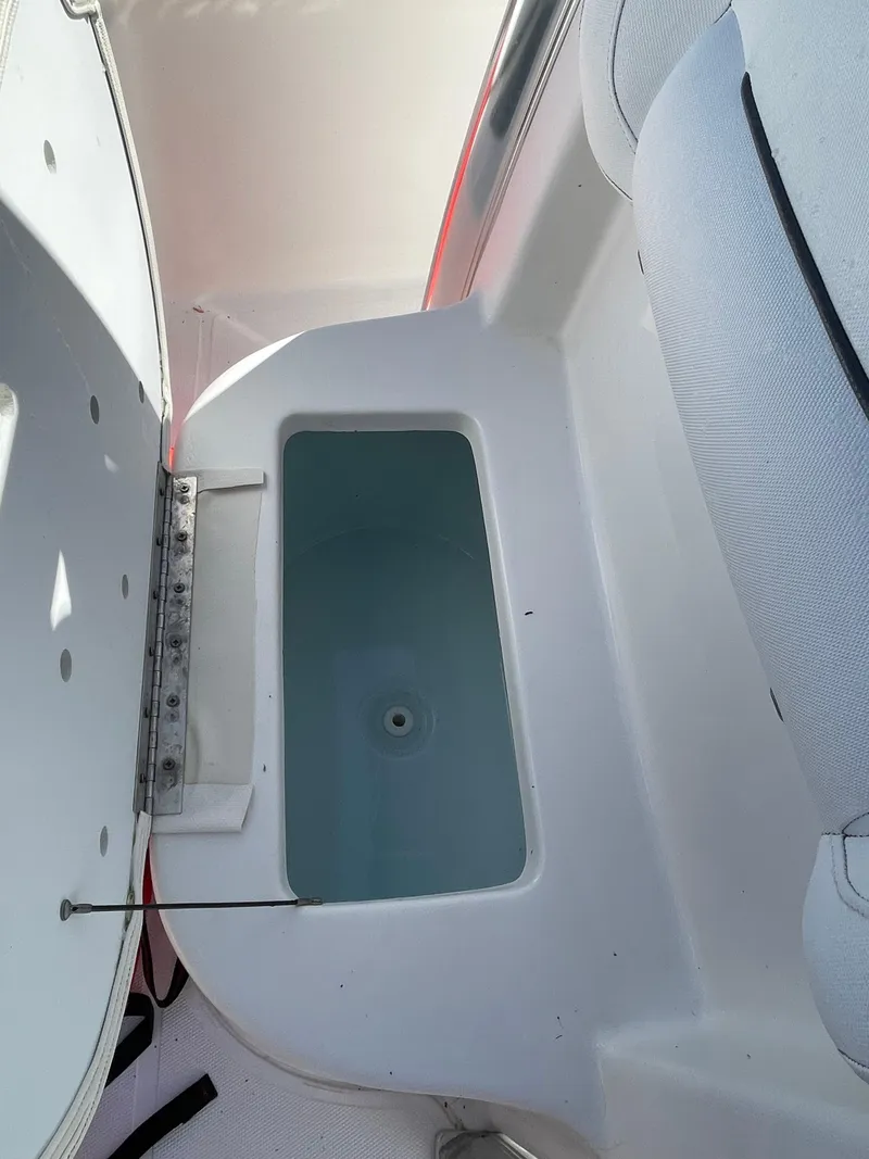Slide: The Image of Open storage compartment on 2017 Sea Hunt 225 Ultra boat with 2021 trailer. - 26