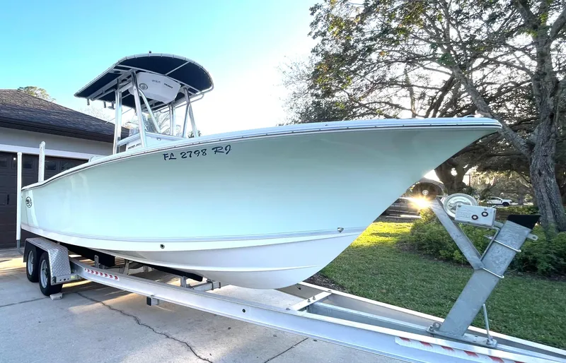 Slide: The Image of 2017 Sea Hunt 225 Ultra boat on trailer, side view, parked outdoors. - 3