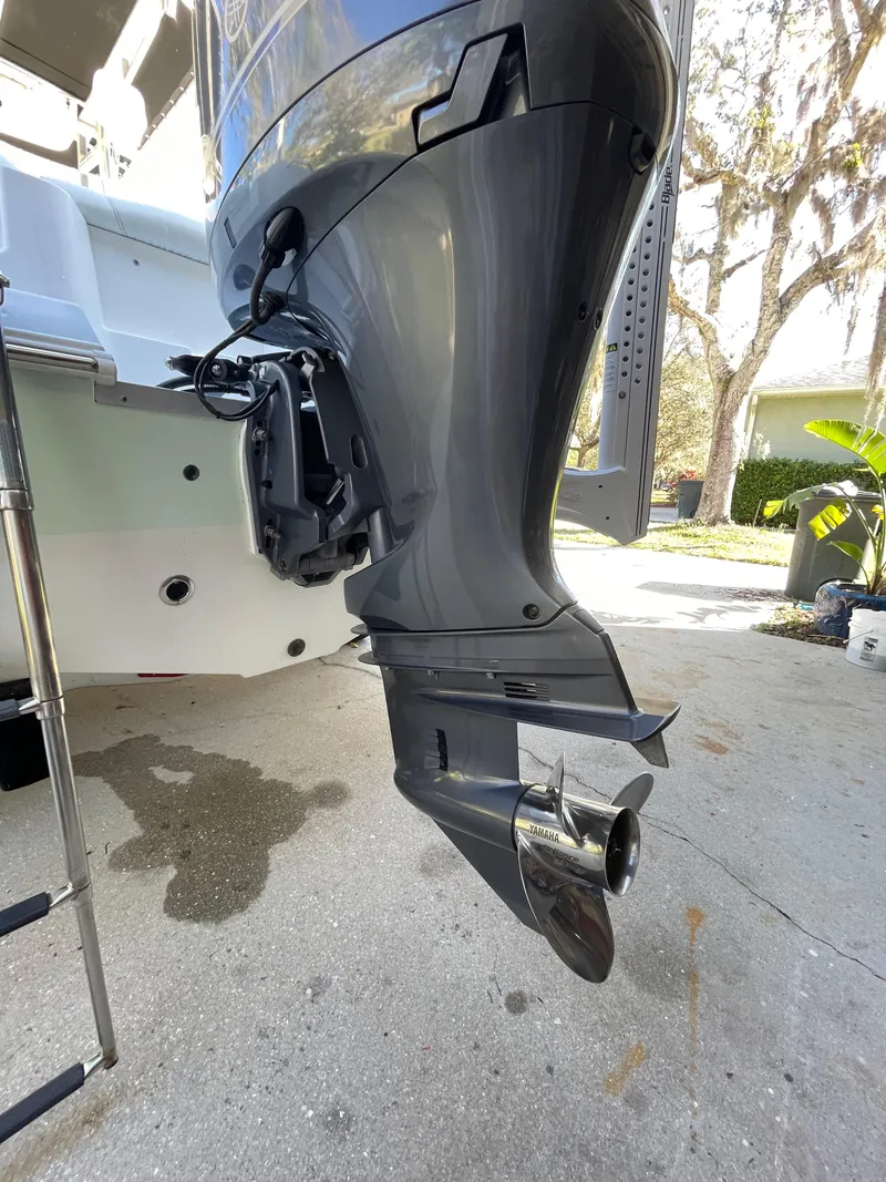 Slide: The Image of 2017 Sea Hunt 225 Ultra boat engine, close-up view, showcasing propeller and lower unit. - 5