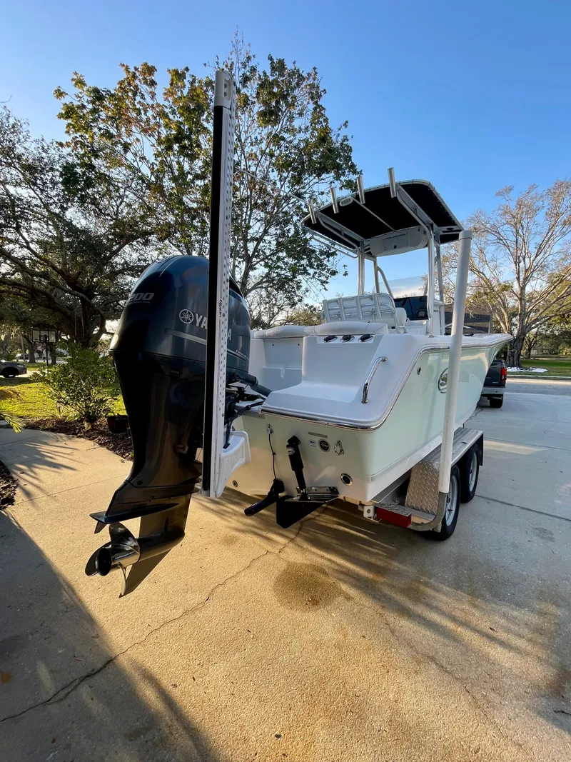 Slide: The Image of 2017 Sea Hunt 225 Ultra boat with trailer, Yamaha engine, parked outdoors. - 6