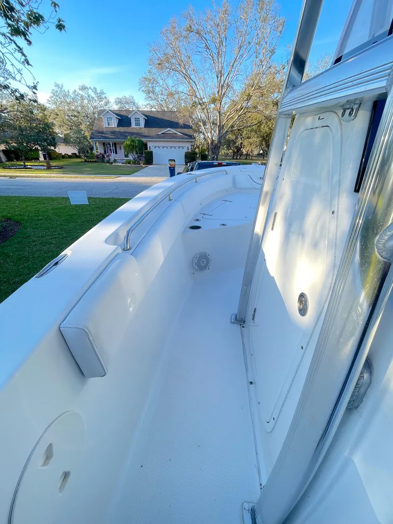 Slide: The Image of 2017 Sea Hunt 225 Ultra boat, side view, parked in residential area, clear sky. - 9