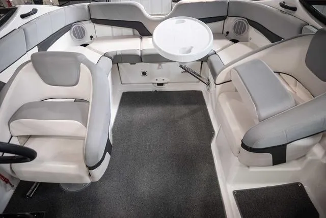 Slide: The Image of 2012 Yamaha Boats 212SS interior with seating and table, featuring gray and white upholstery. - 13