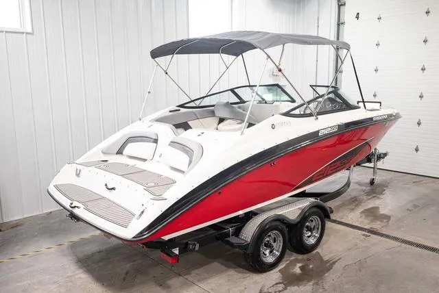 Slide: The Image of 2012 Yamaha Boats 212SS in a garage, featuring a red and white design with a canopy. - 3