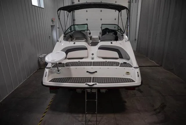 Slide: The Image of 2012 Yamaha Boats 212SS in a garage, rear view with swim platform and ladder. - 5