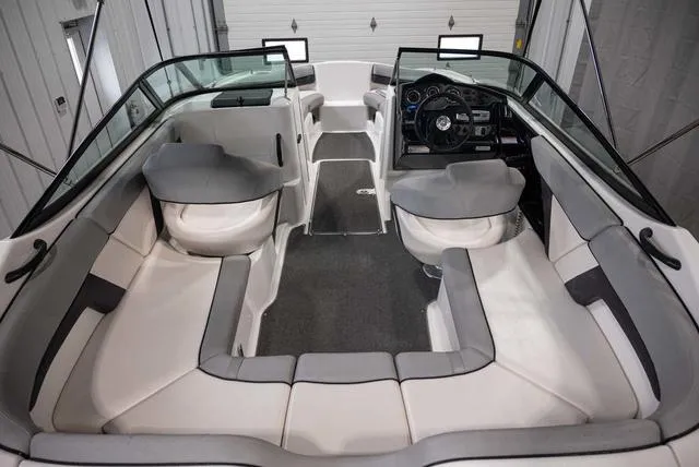 Slide: The Image of 2012 Yamaha Boats 212SS interior with spacious seating and modern dashboard. - 6