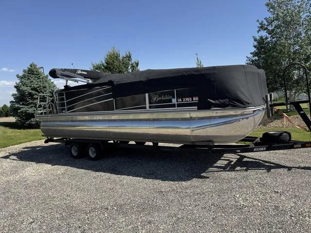Slide: The Image of 2014 Berkshire STS Series 233SL BP3 pontoon boat on trailer, covered, parked outdoors. - 4