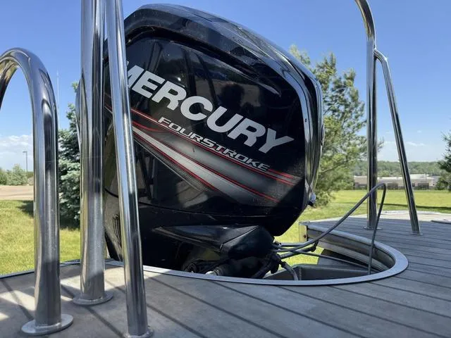 Slide: The Image of Mercury FourStroke engine on 2014 Berkshire STS Series 233SL BP3 boat, sunny outdoor setting. - 5