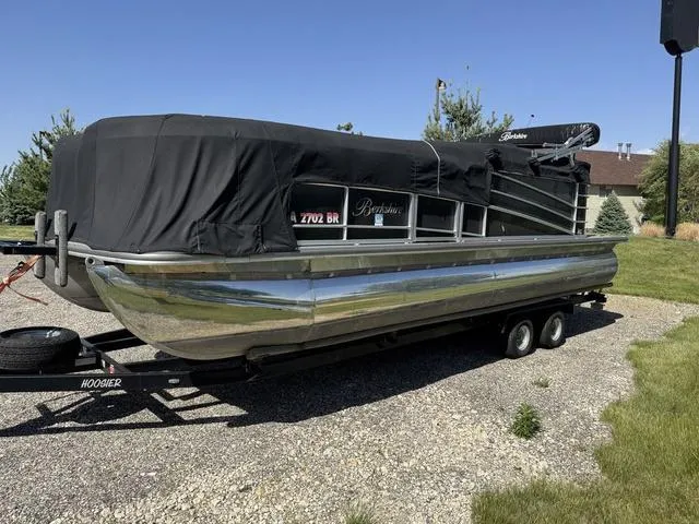 Slide: The Image of 2014 Berkshire STS Series 233SL BP3 pontoon boat on trailer, covered, parked outdoors. - 7