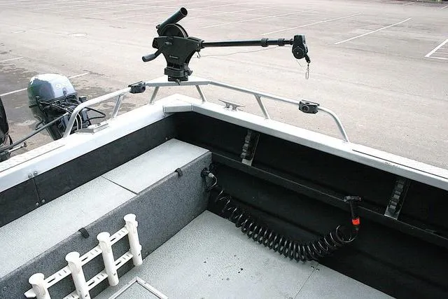 Slide: The Image of 2003 Thunder Jet 19 Luxor boat interior with fishing rod holder and motor. - 12