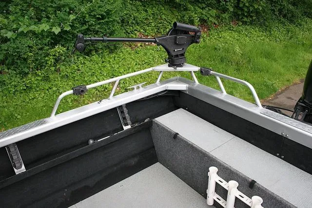 Slide: The Image of 2003 Thunder Jet 19 Luxor boat interior with mounted equipment and lush greenery background. - 13