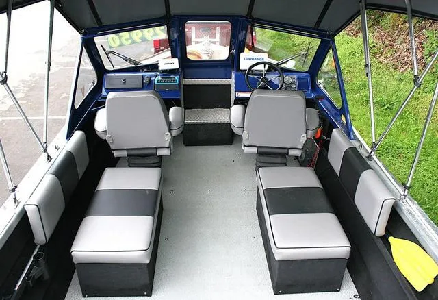 Slide: The Image of Interior of a 2003 Thunder Jet 19 Luxor boat with seating and steering console. - 5