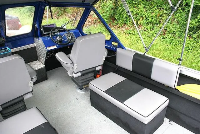 Slide: The Image of Interior of 2003 Thunder Jet 19 Luxor boat with seating and steering console. - 6
