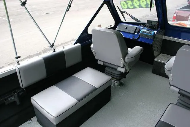 Slide: The Image of Interior of a 2003 Thunder Jet 19 Luxor boat with gray seating and control panel. - 7