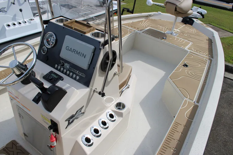 Slide: The Image of 2025 Xpress H22B boat interior with Garmin system and steering console. - 13