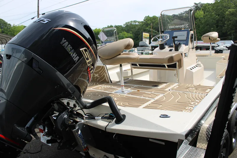 Slide: The Image of 2025 Xpress H22B boat with Yamaha engine, featuring spacious deck and modern seating. - 14