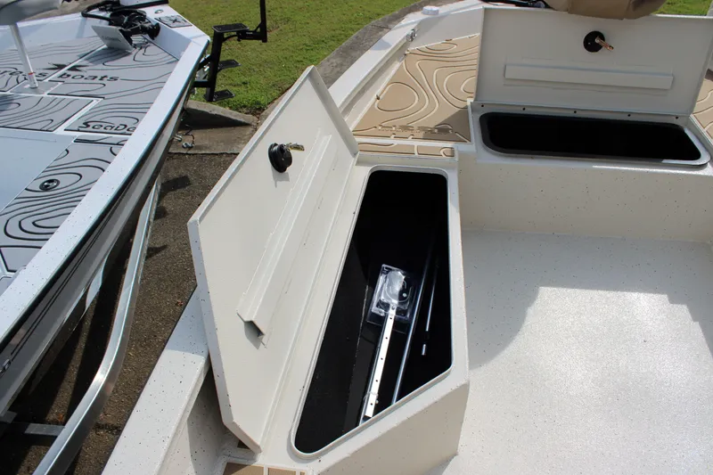 Slide: The Image of 2025 Xpress H22B boat storage compartments open, showcasing interior space and design. - 4
