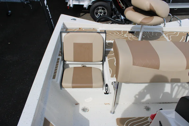 Slide: The Image of 2025 Xpress H22B boat interior with beige and brown seating. - 9