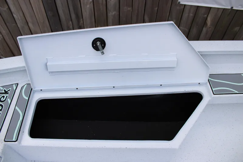 Slide: The Image of Open storage compartment on 2025 Xpress H22B boat, showcasing interior space. - 11