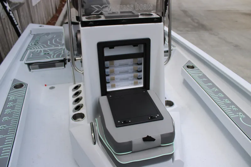 Slide: The Image of 2025 Xpress H22B boat console with storage compartments and measuring guides. - 13