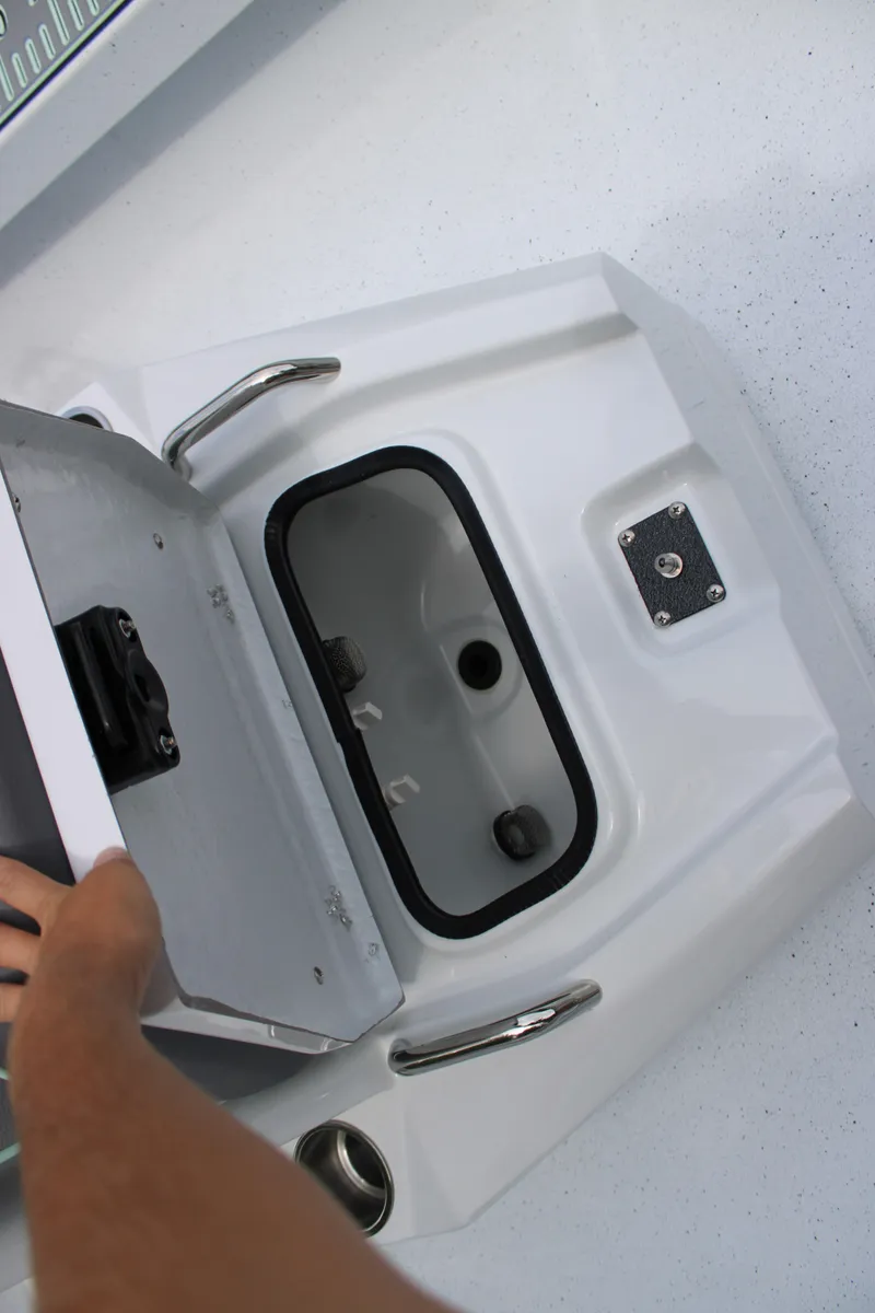 Slide: The Image of 2025 Xpress H22B boat storage compartment with open lid and handle. - 14