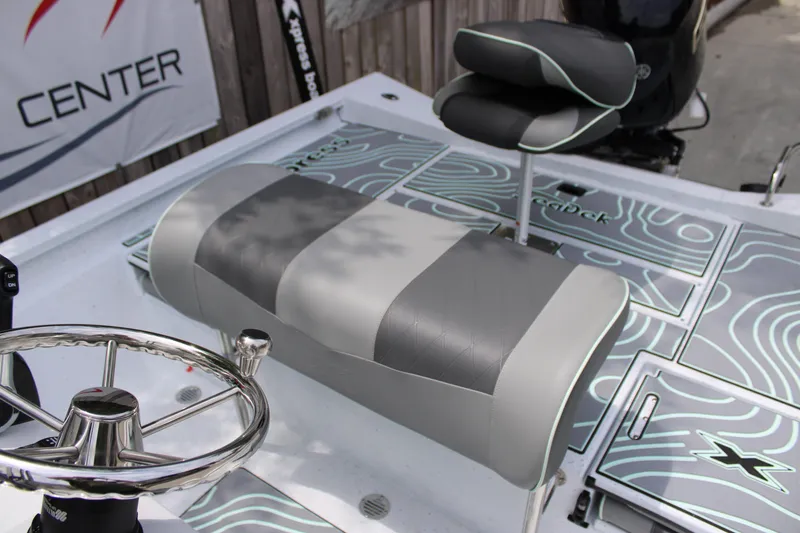 Slide: The Image of 2025 Xpress H22B boat interior with stylish seating and modern steering wheel design. - 17