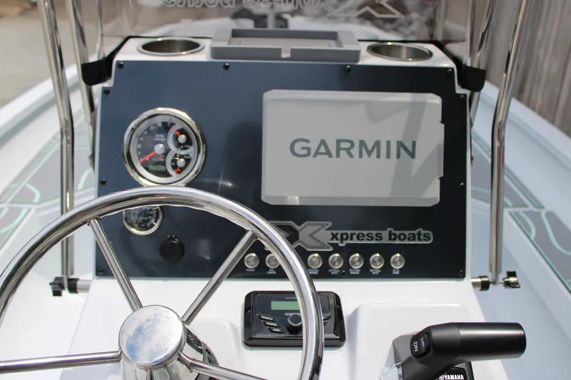 Slide: The Image of 2025 Xpress H22B boat dashboard with Garmin display and steering wheel. - 18