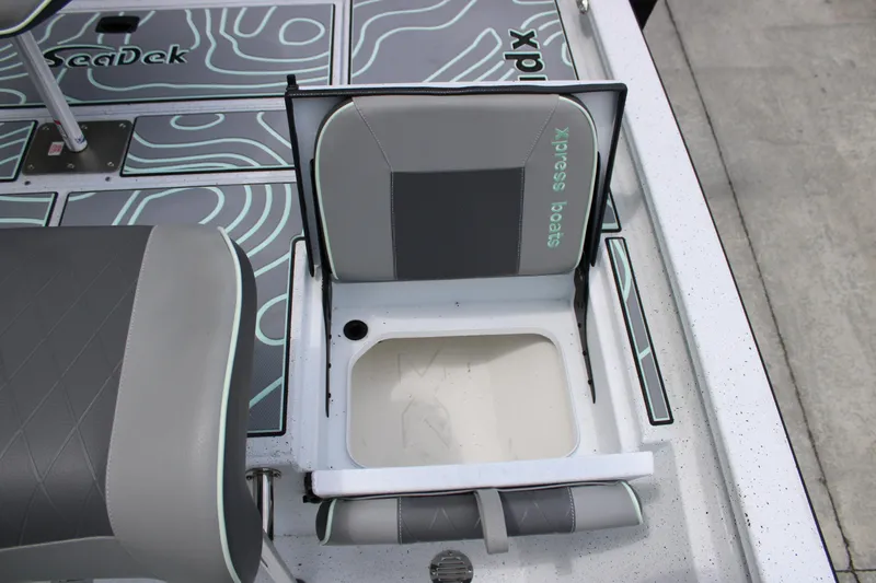 Slide: The Image of 2025 Xpress H22B boat seat with storage compartment, featuring SeaDek flooring. - 21