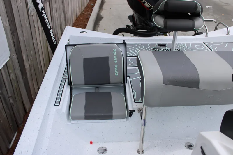 Slide: The Image of 2025 Xpress H22B boat interior with gray seating and modern design. - 22