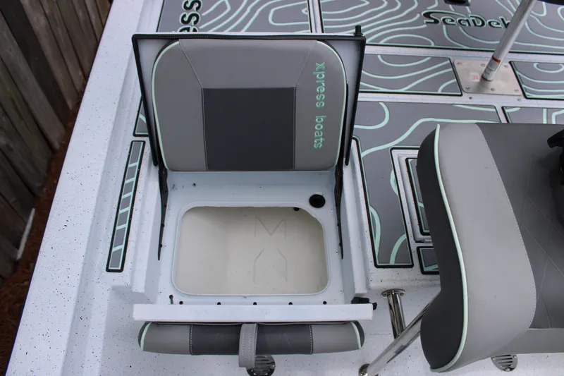 Slide: The Image of 2025 Xpress H22B boat seat with storage compartment, featuring gray and black design. - 23