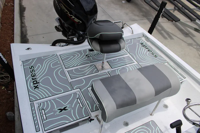 Slide: The Image of 2025 Xpress H22B boat deck with seating and motor, featuring stylish design and branding. - 24