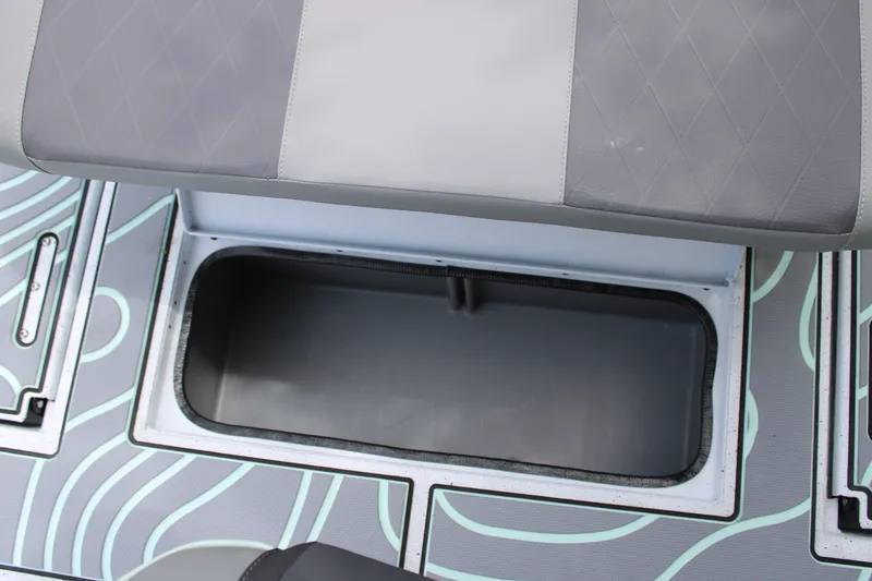 Slide: The Image of 2025 Xpress H22B boat storage compartment with cushioned seating and patterned flooring. - 26