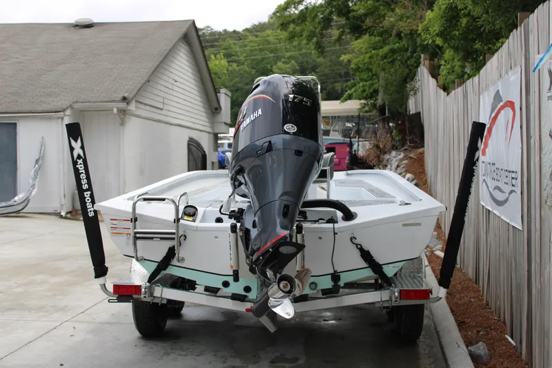 Slide: The Image of 2025 Xpress H22B boat on trailer with Yamaha outboard motor, parked outdoors. - 3