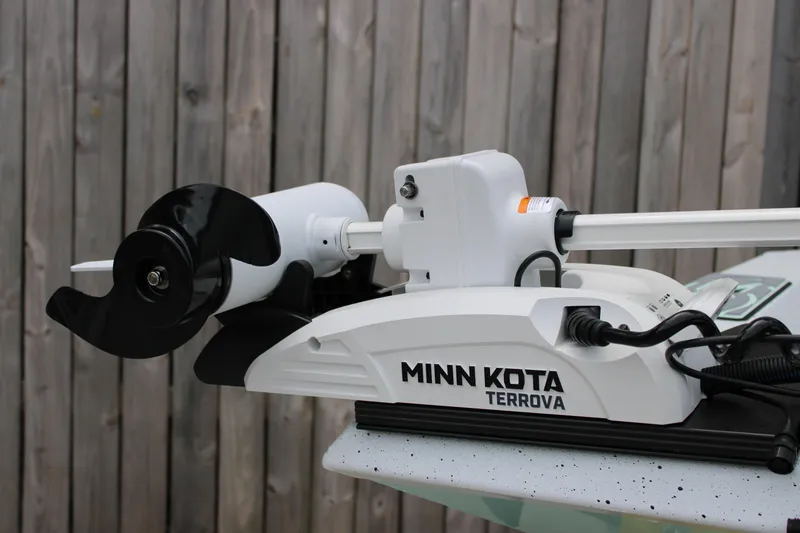 Slide: The Image of Minn Kota Terrova trolling motor on Xpress H22B, 2025 model, against wooden background. - 4