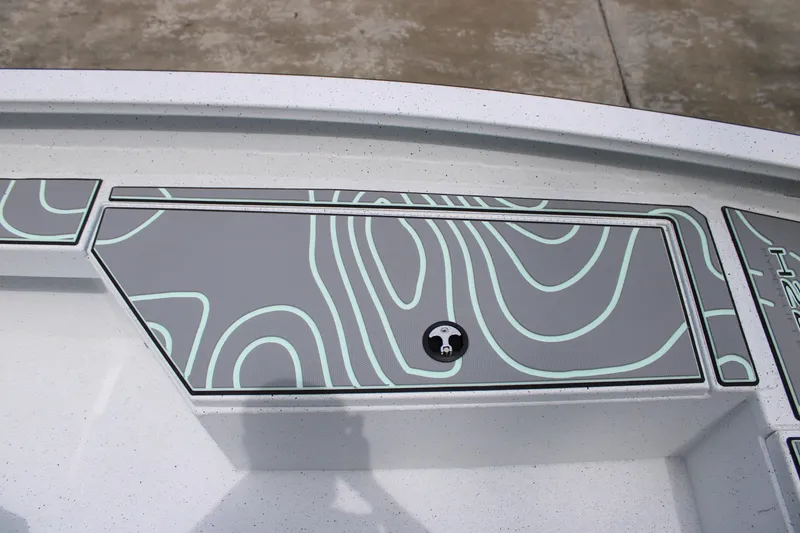 Slide: The Image of 2025 Xpress H22B boat deck with stylish contour design and secure storage compartment. - 8