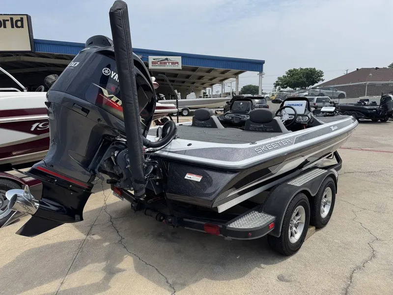 Slide: The Image of 2017 Skeeter ZX200 boat with Yamaha engine on a trailer at a dealership. - 2