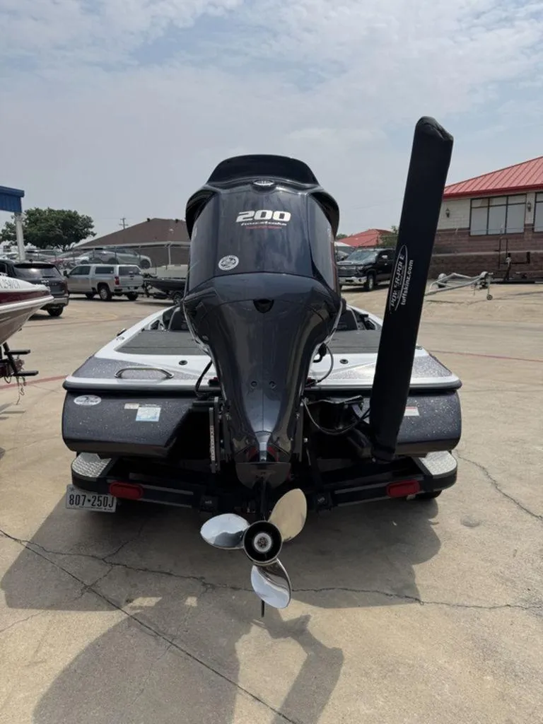 Slide: The Image of 2017 Skeeter ZX200 boat with outboard motor, parked on concrete surface. - 8