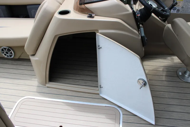 Slide: The Image of 2025 Starcraft SLS-3 Q DH boat interior with open storage compartment and beige seating. - 11