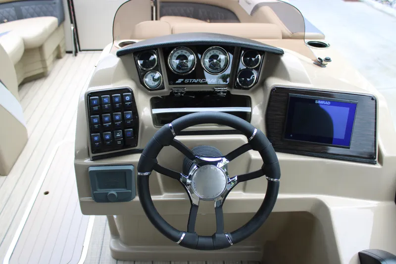 Slide: The Image of 2025 Starcraft SLS-3 Q DH boat dashboard with steering wheel and control panel. - 15